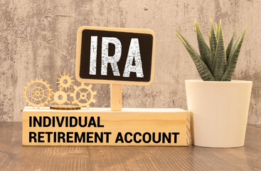 On a bright blue background, light wooden blocks and cubes with the text IRA Individual Retirement Account