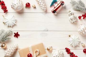 Christmas white wooden desk table with aesthetic Christmas decorations and red ornaments. Vintage Christmas card template.