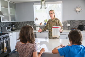 Air Force service member having breakfast with kids before work.