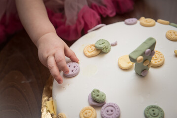 Little girl touches birthday pie