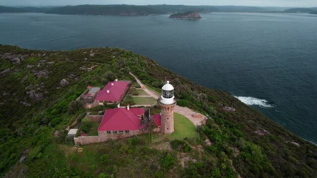 Drone shot of a beacon with buildings on cliff by Hawkesbury River in Jerusalem Bay