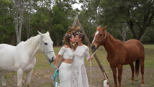 Lesbian wedding first kiss with horses
