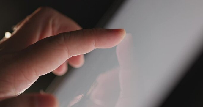 4K Video slow motion close up finger touch on tablet screen. Video Background for technology and digital life.