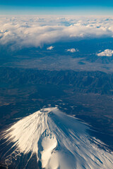 Bird Eye View shot of Fuji Mountain at Japan on Airplane with Blue Sky and Cloud