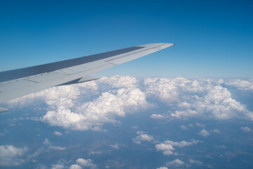 airplane wing and sky clouds