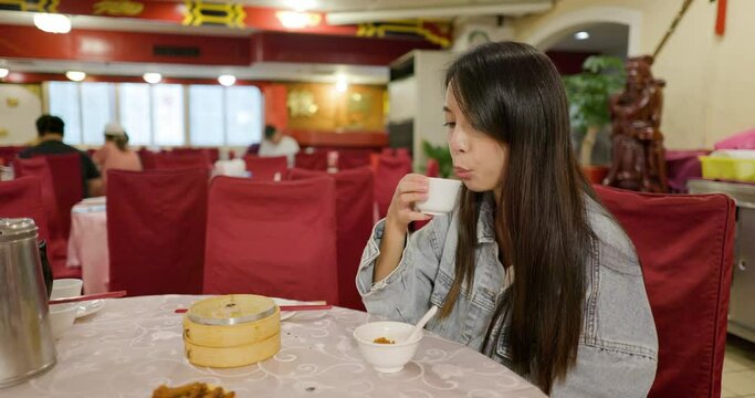 Woman drink with hot teat at restaurant
