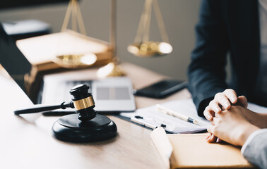 Female Lawyer  Litigation Trial Lawyer office. Statue of Justice with scales and lawyer working on a laptop. Legal law, advice and justice concept.