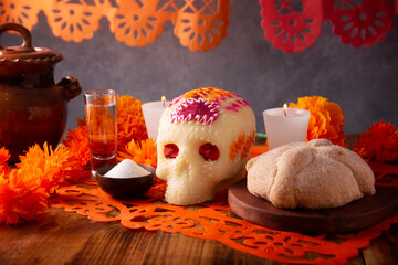 Pan de Muerto with sugar skull and Cempasuchil flowers or Marigold and Papel Picado. Decoration...