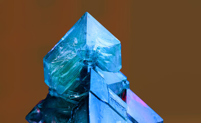 blue crystalline mineral on brown background