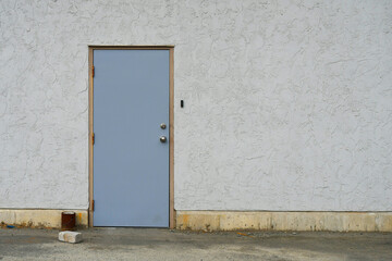 Obraz na płótnie Canvas Closed and locked industrial steel door on an exterior wall.
