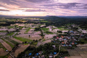 Top view sunset rice farm beside village
