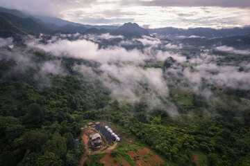 Mountain from view with small village and flow fog
