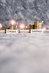 Cheque savings and credit account texts in front of growing stacks of coins. Concept of money,...