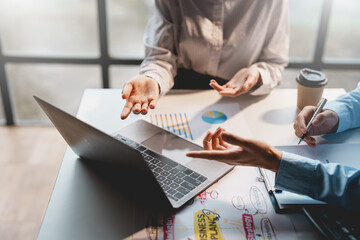 Image of businessman hand pointing at laptop computer meeting. Business team figures, graphs,...