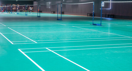 Many people playing badminton indoor