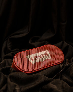 Bankura, West Bengal, India - September 24, 2022: Levi's Bluetooth speaker with FM radio place into folds of a black satin cloth