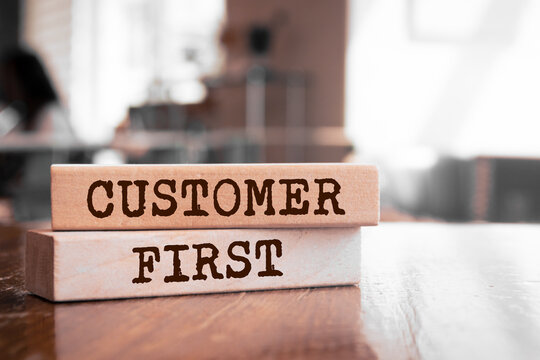 Wooden blocks with words 'Customer First'.