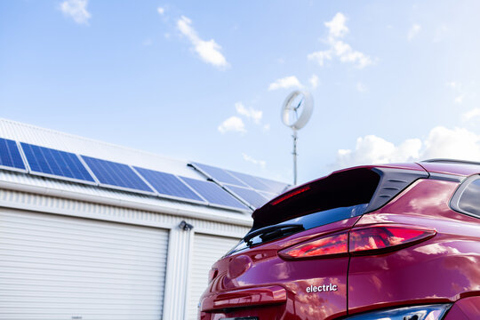 sustainable off grid living with electric vehicle car and solar power and wind turbine