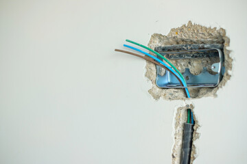 Electrical Wiring under plaster, hidden installation cables for socket to a concrete. Renovation, Repair and development of home and apartment concepts
