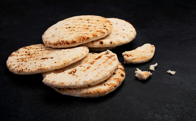 .Pita bread on dark background. Arabic, lebanese bread, traditional food.