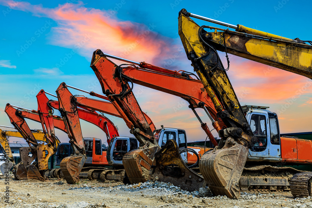 Wall mural Construction site excavator equipment scene at sunset