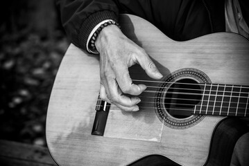 Closeup of musician playing guitar in the street - 541135435