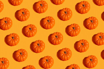 From above view of ripe orange pumpkins placed in rows on blue wooden background