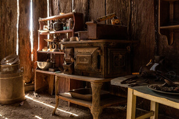Sunlight shining through gaps in wall of old timber farm building.