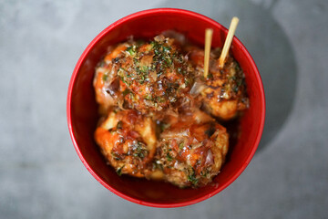 traditional Japanese food, takoyaki with sauce on a cutting board
