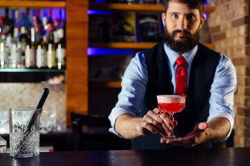 Bartender serve cocktail drink for customer at the bar