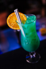 Close up of barman decorate blue lagoon cocktail