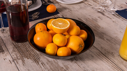 Rustic table setting with pink flowers and candle on light wooden table. Holidays decoration on Provence style. Romantic dinner. Overhead