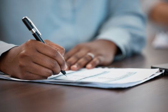 Hands, documents and contract with a black man signing paperwork at a table or desk in the office. Compliance, loan and insurance with a male putting his signature on a legal document for agreement