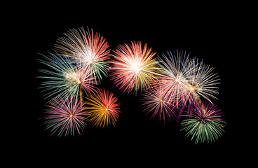 Colorful fireworks exploding on the black sky. Celebration and anniversary concept.