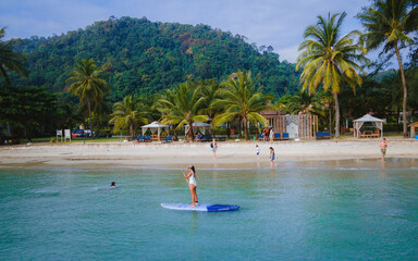 Thai women paddling at a sup board in Koh Chang Thailand. stand-up paddleboard
