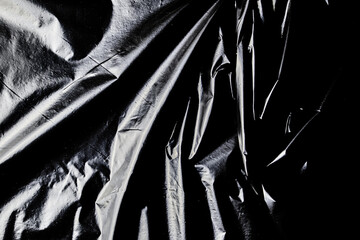 black cellophane bag close-up background texture of plastic
