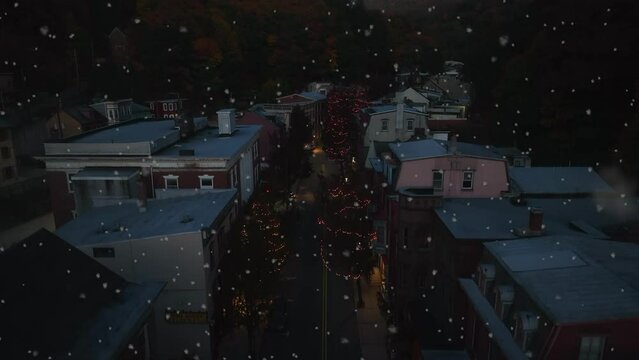 Small Town America Christmas Theme. Snowflakes At Night With Trees On Lights. Homes In Quiet Christmas Eve Aerial Establishing Shot.