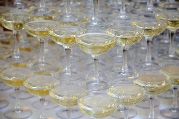 Crystal glasses for holiday, a lot of glasses for guests. Slide pyramid of glasses.