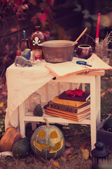 Happy halloween Carving pumpkin on the table in the garden. Happy family preparing for Halloween.