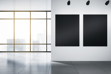 Two blank black posters with space for your logo or text on light wall in sunlit empty office with grey floor and city view from panoramic window. 3D rendering, mockup