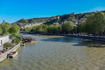 View of the Kura river from the bridge on a clear Sunny day. Kura river in the center of Tbilisi. April 2019 Georgia.
