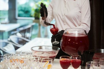 The process of pouring a punch or other drink into glasses at an event.