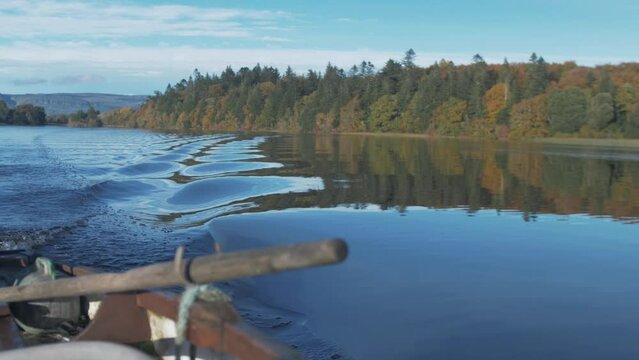 Autumn woodland colours seen from rowboat Rack Focus from oarlock