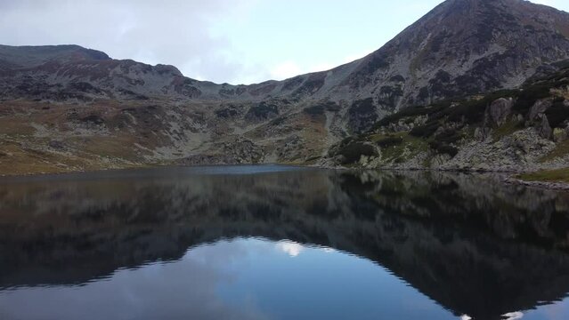 Aerial slow movement around Bucura lake surrounded by Carpathian mountains
