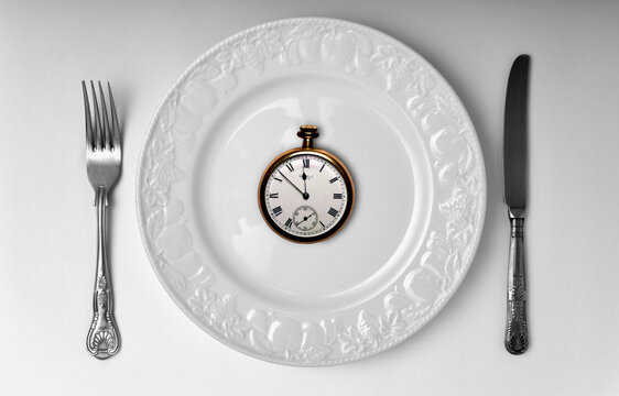 Watch on a plate, conceptual image