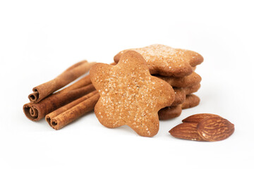Ginger star cookies with sugar, cinnamon and almonds on a white blurred background. Christmas recipe
