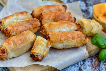  Greek style Mini filo pastry rolls with bacon and cheddar cheese .Home made bakery .Fresh baked  Mini cheese  ,meat and herbs puff pastries