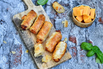  Greek style Mini filo pastry rolls with bacon and cheddar cheese .Home made bakery .Fresh baked  Mini cheese  ,meat and herbs puff pastries