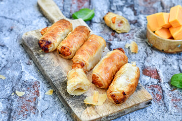 Greek style Mini filo pastry rolls with bacon and cheddar cheese .Home made bakery .Fresh baked  Mini cheese  ,meat and herbs puff pastries