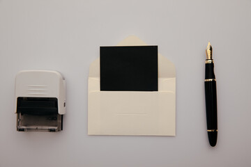 Notary public stamper. White envelope with card, stamp and pen